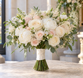 Romantic Touch bridal bouquet with ivory roses, blush flowers, and natural foliage in a bright wedding setting